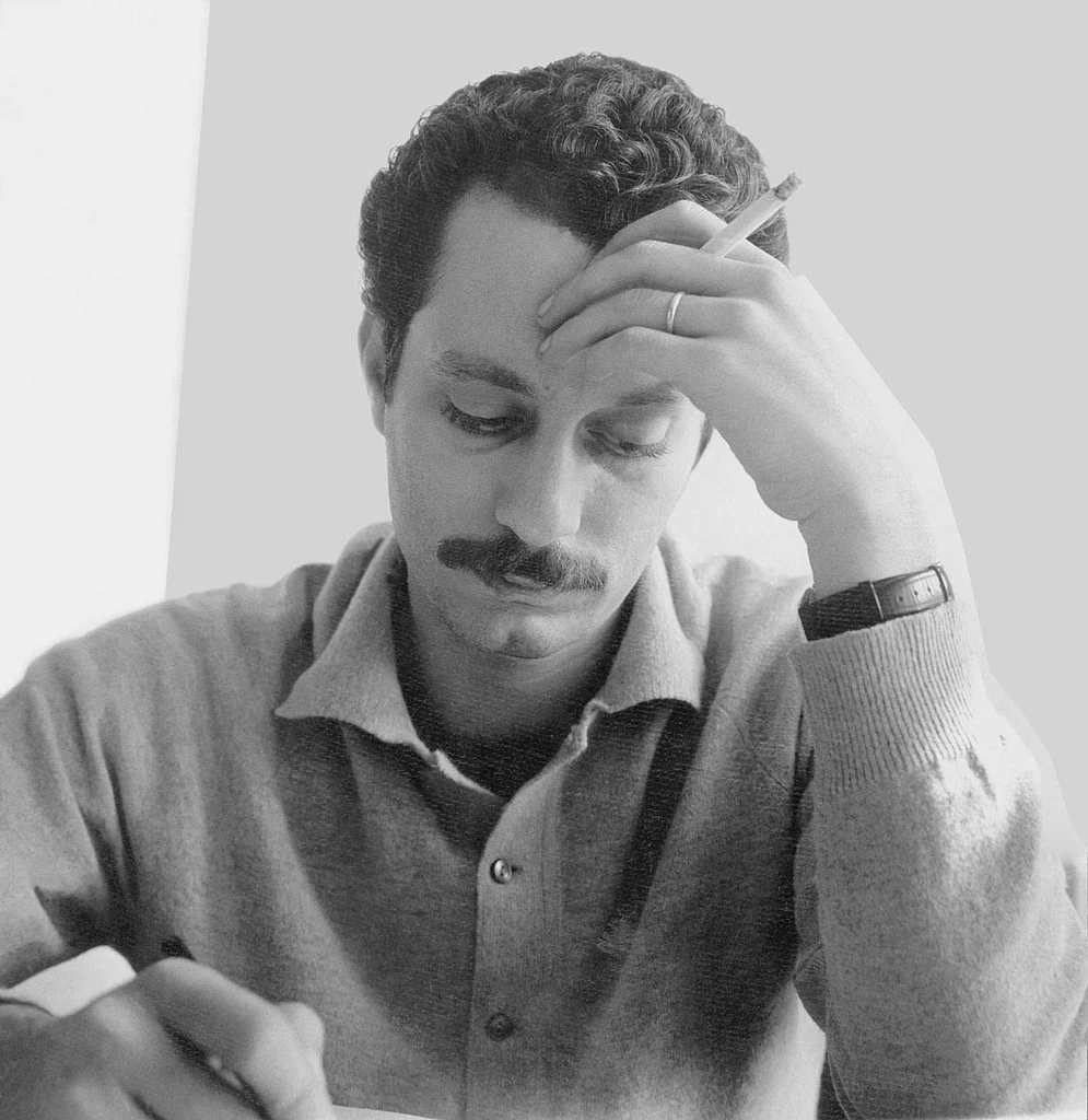 Ghassan Kanafani seated at his desk